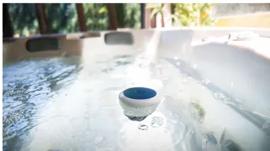 A blue and white bowl floating in the water.